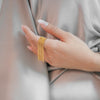 Ria Gold gold plated statement ring featuring cascading rows of delicate beaded fringe worn by a model by Eda Jewels Dubai